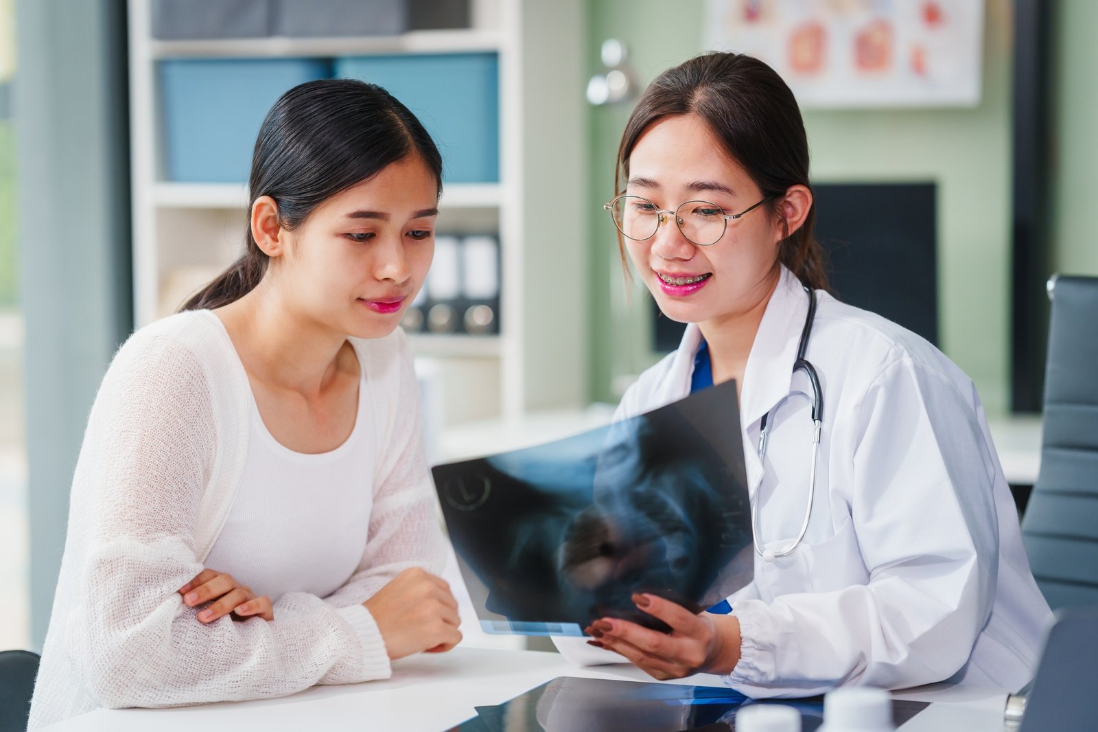 Asian female doctor specializing in psychiatry works her desk, providing psychotherapy, diagnosis